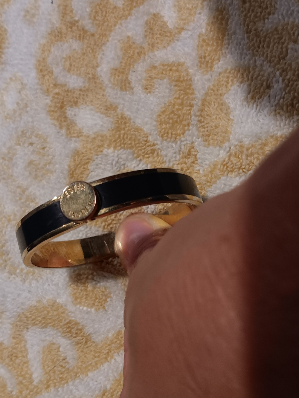 Estee Lauder Gold-Tone Bangle with Black Enamel Accent